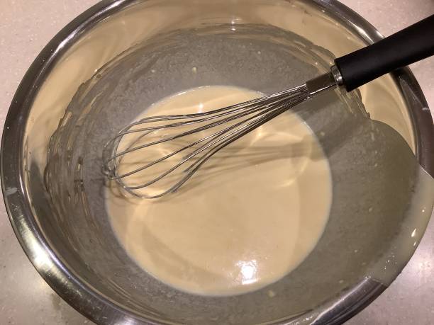 istock A hot cake made by milk, eggs and flour in a bowl with a whisk 1457913630