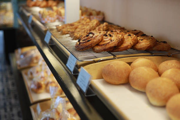 istock Freshly baked pastry and bread bun on a display in bakery shop 1457913745