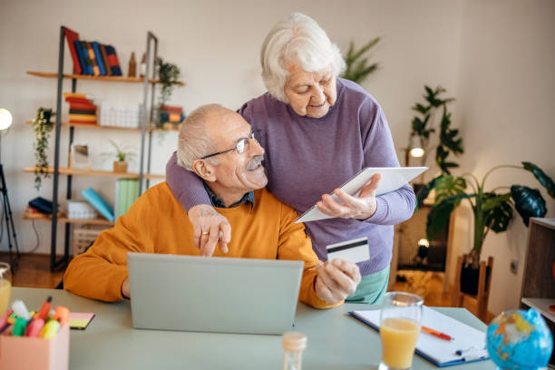 istock Old couple shopping online at home 1457916077