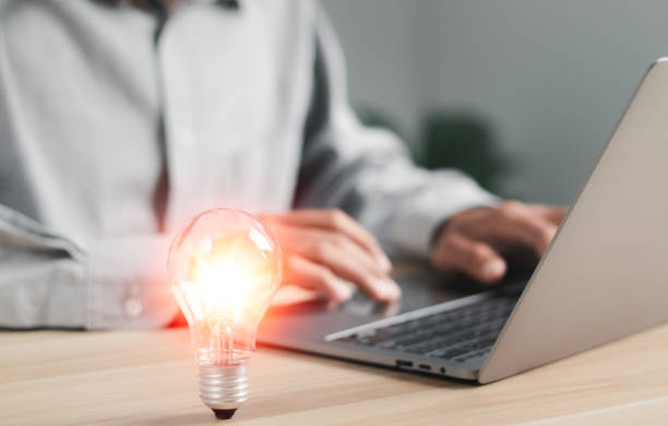 istock Businessman holding light bulb and new business idea, creative and inspirational, technological innovation. 1457916829