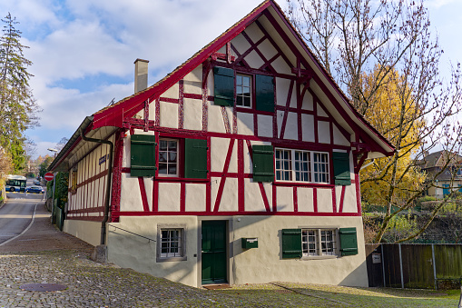 Beautiful historic former half timbered farm house at City of Zürich on a blue cloudy autumn day. Photo taken December 8th, 2022, Zurich, Switzerland.