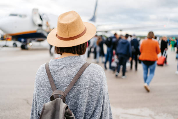istock Young Woman Boarding An Airplane 1457923274
