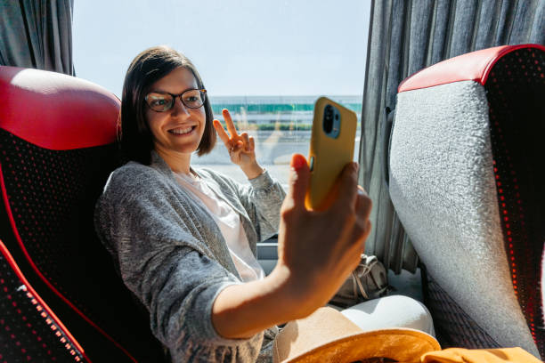 istock Young Woman Taking Selfies Using Phone In The Bus 1457924043