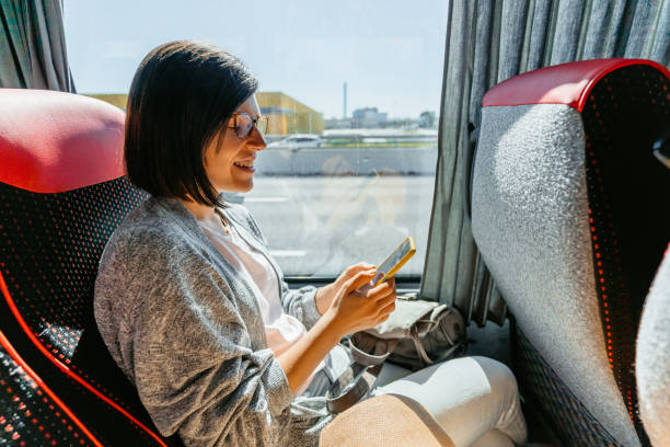 istock Young Woman Using Smart Phone In The Bus 1457924074