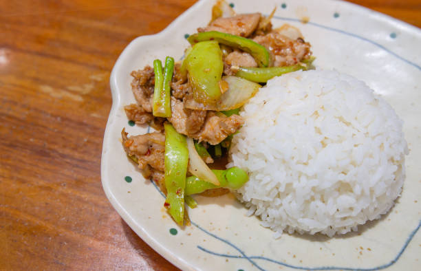 istock Stir Fried Green Pepper with Pork and Jasmine Rice 1457925369