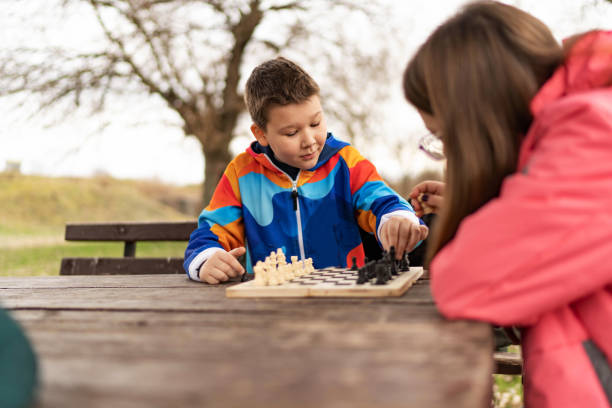 istock Brother and sister playing chess together 1457927165