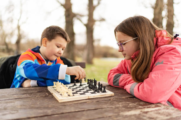 istock Brother and sister playing chess together 1457927176