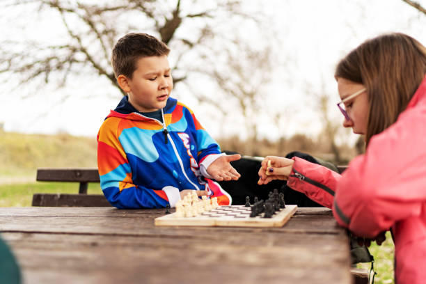 istock Brother and sister playing chess together 1457927185