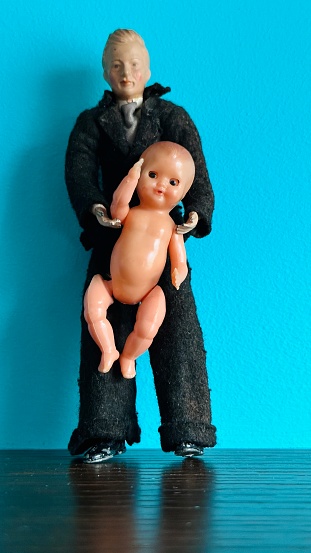 Vintage puppet man holding a baby