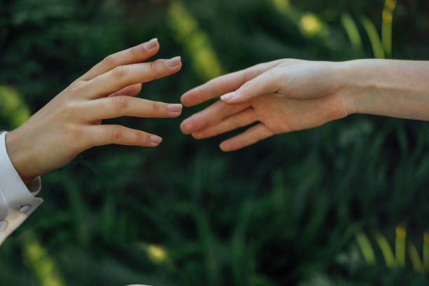 istock Close up of a woman's hand touching the grass, feeling nature 1457930094