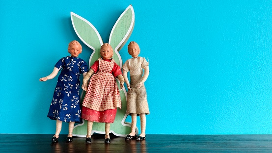 Vintage puppets, three women standing at a green rabbit