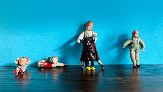 Vintage puppets standing and lying at a blue background