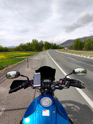 Kashmir, India - April 19 2021 : motorcycle rider in kashmir valley of himalayas.