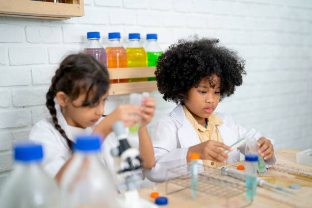 istock Two little girls practice in science class with different laboratory equipment with concentrate in their work. 1457932268