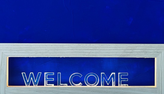 Welcome sign on dark blue background