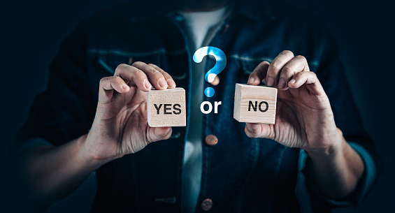 Choices for Business achievement, confusion, decision and solution Concept. Businessman holding wooden block with yes or no text for marketing decide solution