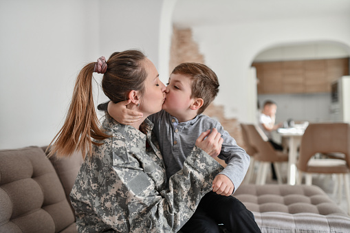 Female Soldier Kissing Child Son Before Going To Work