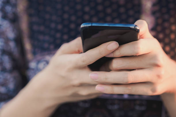 istock Selective focus on Young woman hand while using a mobile phone by texting the message to communicate with someone, copy space 1457934985