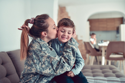 Female Soldier Showing Love And Care Towards Her Son Before Going On Combat Tour