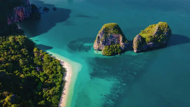 Aerial drone view of Railay beach Krabi Thailand. Railay beach with limestone rocks from the sky and turqouse colored ocean