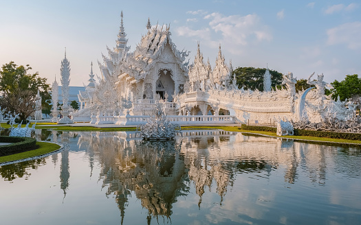 White Temple Chiang Rai Thailand with reflection in the water, Wat Rong Khun or White Temple, Chiang Rai, Northern Thailand.