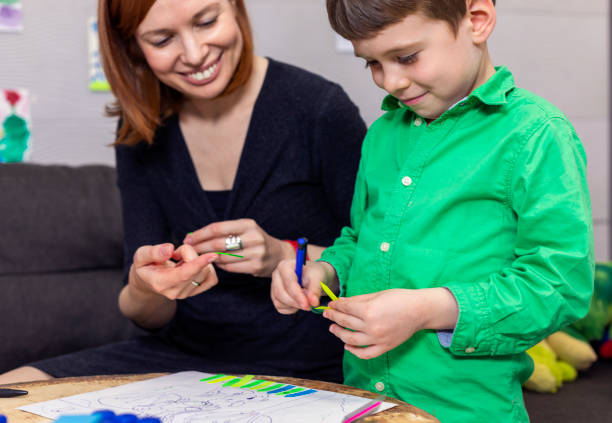 istock Preschool boy in conversation with a psychotherapist 1457938313