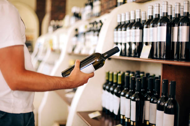 istock Crop man choosing wine in shop 1457942224