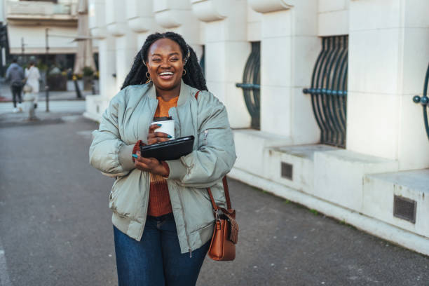 istock Young woman having a coffee to go 1457946152