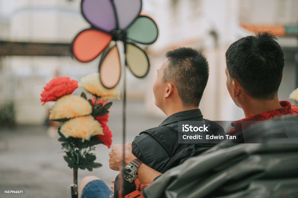 Asian Chinese father and down syndrome son enjoying rickshaw ride in penang old town Active Lifestyle Stock Photo