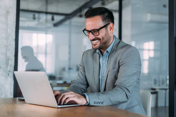 istock Successful businessman in modern office working on laptop. 1457948305