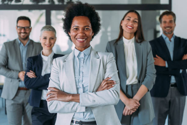 istock Confident businesswoman and her team. 1457948324