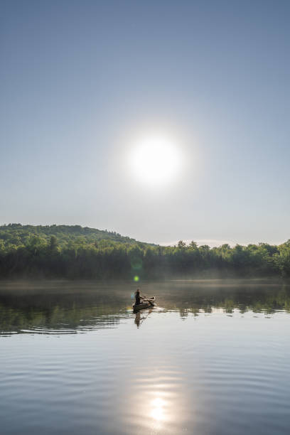 istock A woman canoeing in early morning. 1457949357