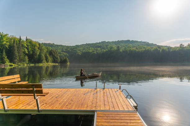 istock A woman canoeing in early morning. 1457949366