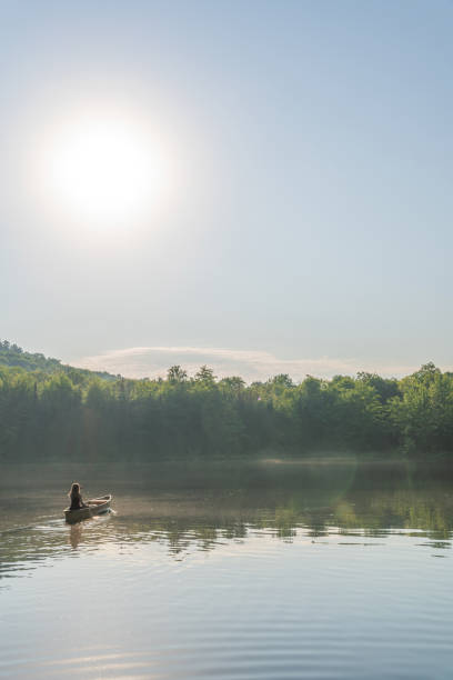 istock A woman canoeing in early morning. 1457949409