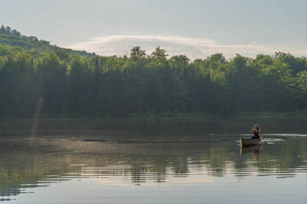 istock A woman canoeing in early morning. 1457949449