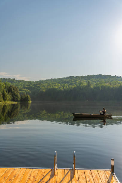 istock A woman canoeing in early morning. 1457949457