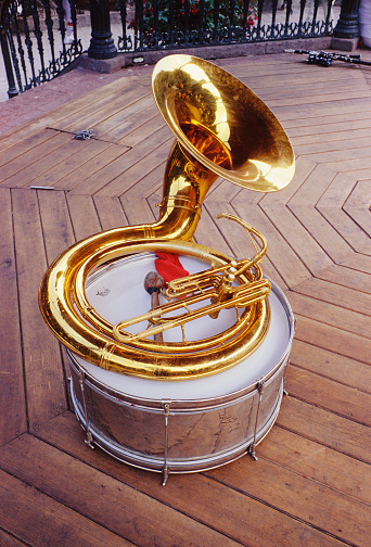 A trombone resting on a drum.