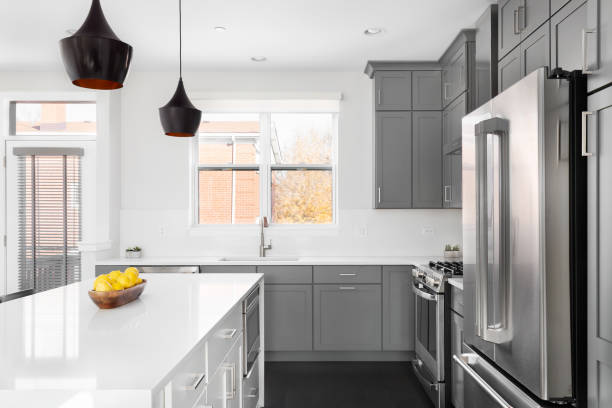 istock A grey and white kitchen with lights hanging over the white island. 1457954671