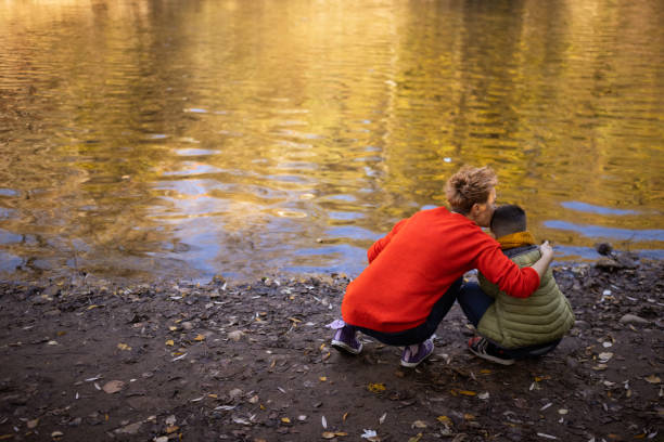 istock Mother and son by the river 1457954784