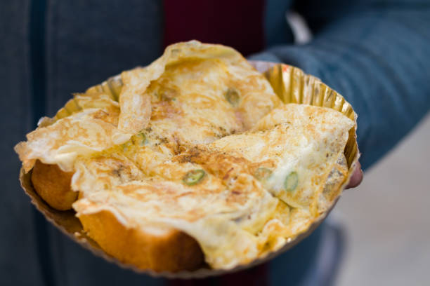 istock egg toast or egg sandwich made with bread and fried egg omelette served on a paper plate as breakfast or snack in kolkata india. It is a very popular roadside dish. 1457956620