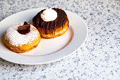 Two Gourmet Donuts Filled with Cream