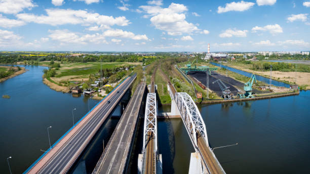 Road and rail bridges on the Oder River. Conventional power plant in the distance, Szczecin, Poland