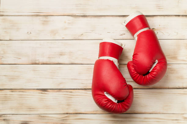 istock Red boxing gloves on wooden background, top view 1457961465