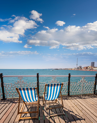 istock Brighton seaside resort beach and Brighton Palace Pier beach lich chair in a summer sunny blue sky 1457963188