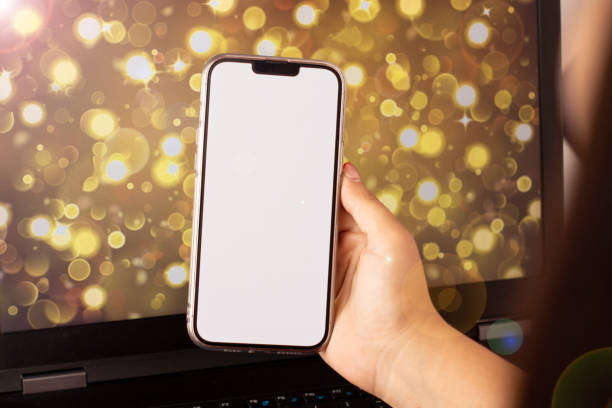 istock woman holding a cell phone with bokeh background 1457965179