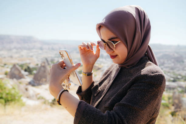 istock asian woman taking selfie portrait using handphone camera 1457965785