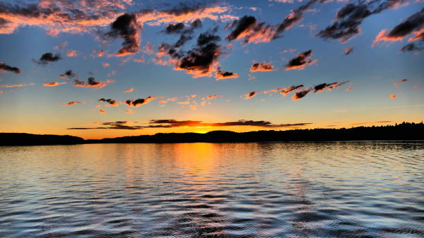 istock Small bright pink clouds at sunset on the Saguenay River 1457965960