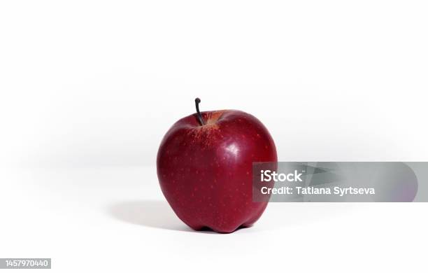 Red Ripe Apple Isolated On White Background With Hard Shadow An Apple Is On The Table In The Kitchen Stock Photo - Download Image Now