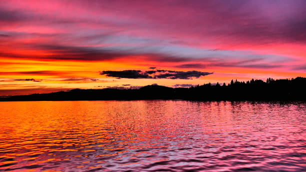 istock Sunset that changes from bright orange to bright pink on the Saguenay River bordered by the silhouette of the mountains 1457971195