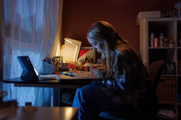 istock A Female Student Working At Home At Night 1457975166